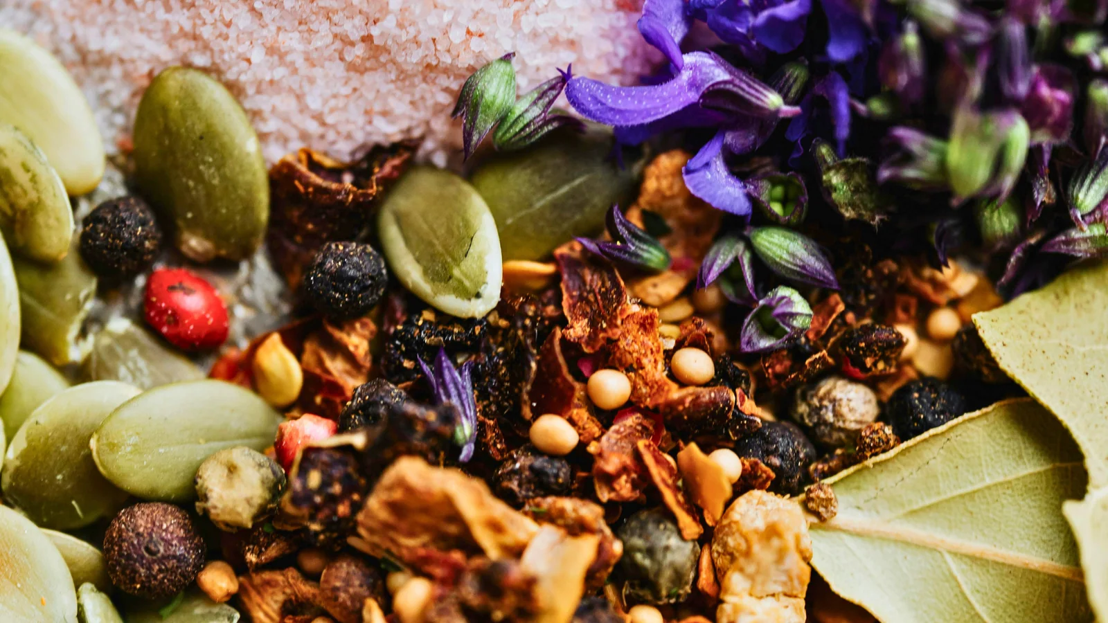 Colorful whole ingredients, seeds, herbs, and flowers in a classic blend